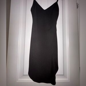 Black mini cocktail dress with V-neck and a slit